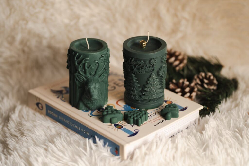 Green Christmas candles on a fluffy background, perfect for cozy winter decor ideas.