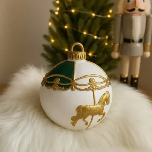 Elegant Christmas candle shaped like a white ornament with golden carousel horse and green accents — festive decorative gift