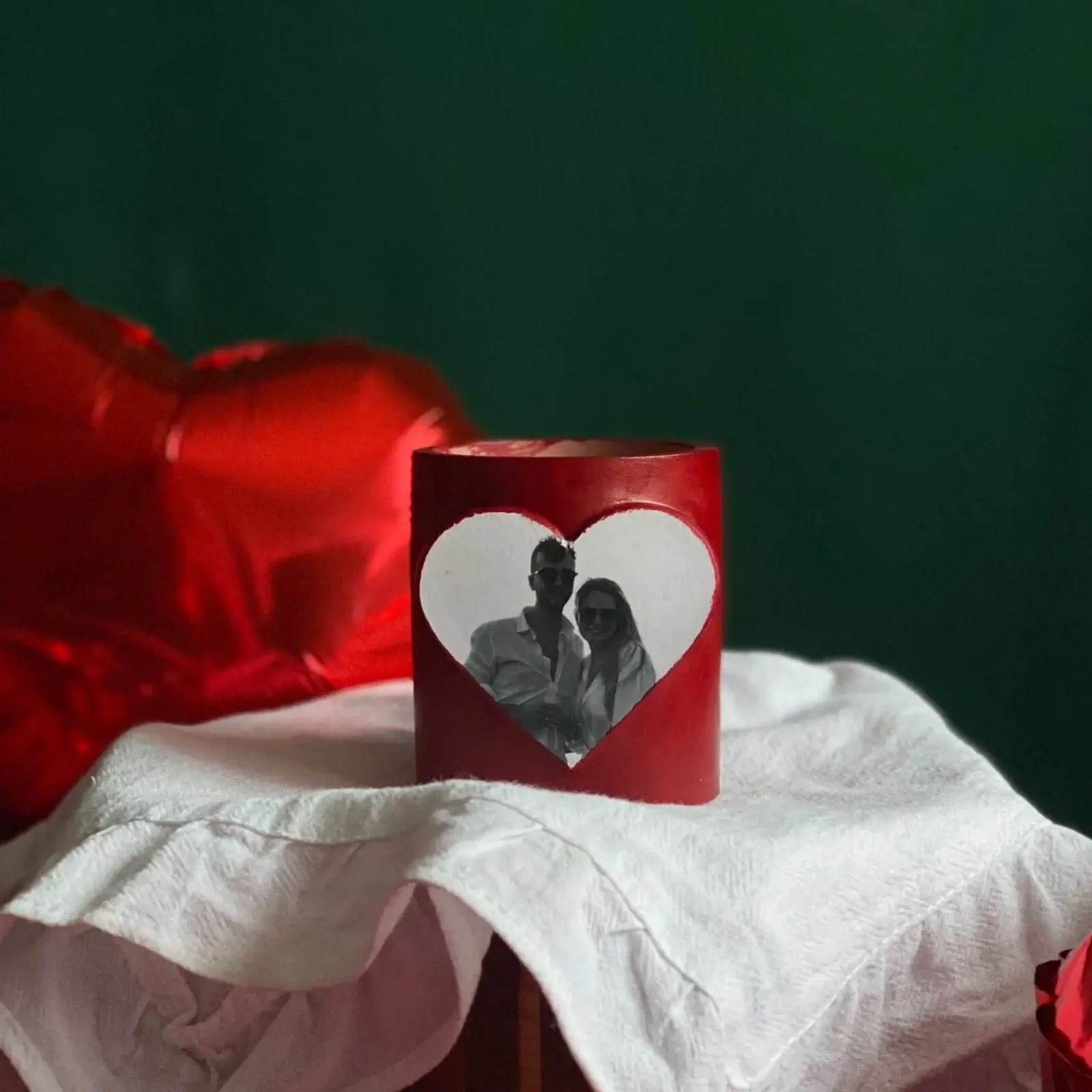 Red Valentine’s Day candle with a custom photo in a heart-shaped frame, perfect romantic gift for couples to celebrate love with a personalized touch.