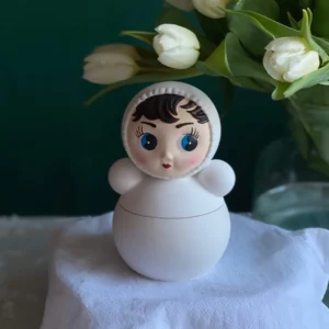 Handmade nevaljashka doll shaped scented candle in minimalist white design, decorative artisan candle for International Women’s Day March 8, cute spring home decor and thoughtful gift for women.