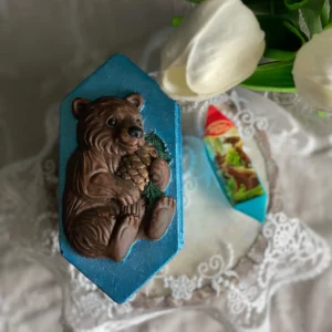 Scented candy-shaped candle with vintage brown bear and pine cone design, nostalgic handmade candle.