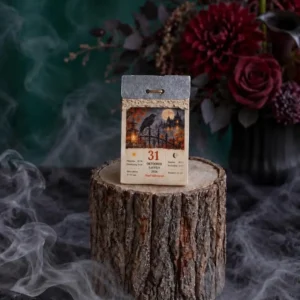 Handmade scented tear-off calendar candle for October 31 with a raven, full moon and haunted castle design.
