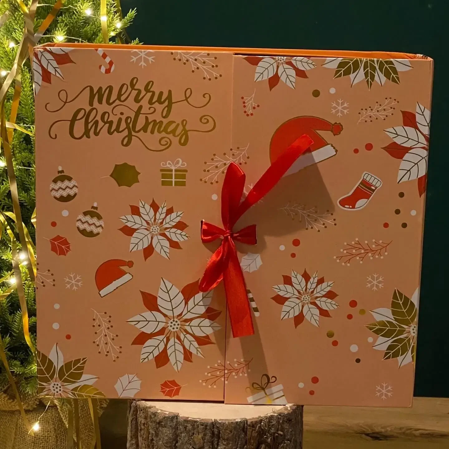 Large Christmas advent calendar gift box with festive print and red ribbon, filled with home fragrance surprises.